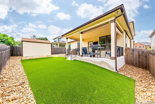 a view of house with backyard and a patio