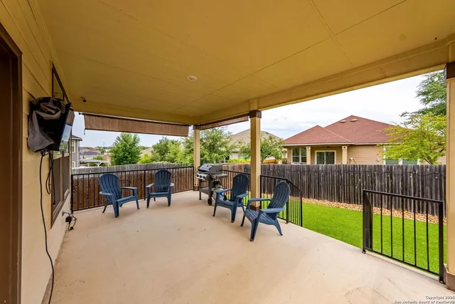 a view of a patio with a table chairs and a backyard