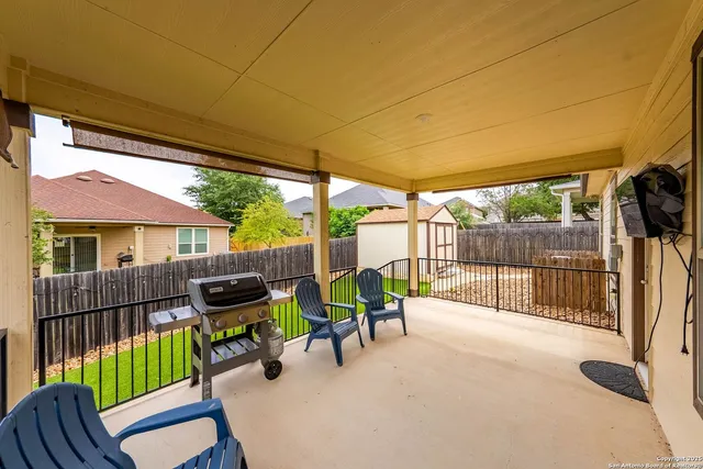 a view of a patio with a table chairs and a backyard