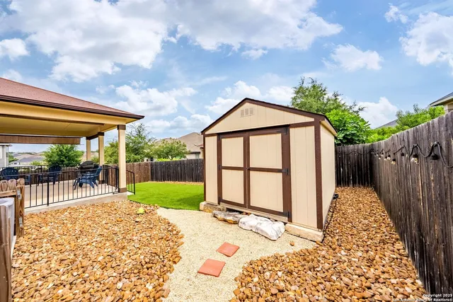 a backyard of a house with table and chairs