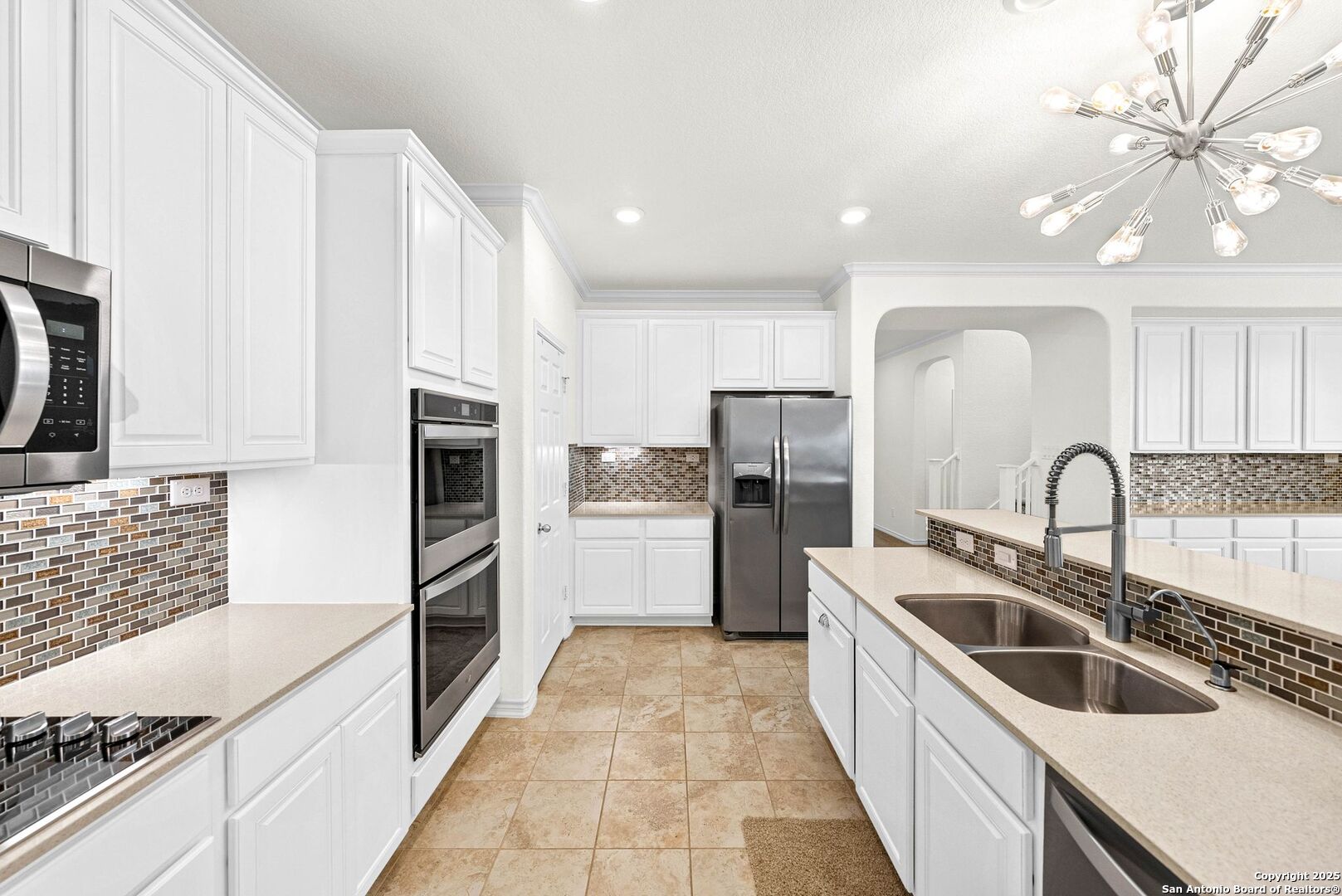 7621 Lorca Boerne, TX 78015 - Photo 8 of 46 a kitchen with stainless steel appliances granite countertop a refrigerator a sink a stove with white cabinets