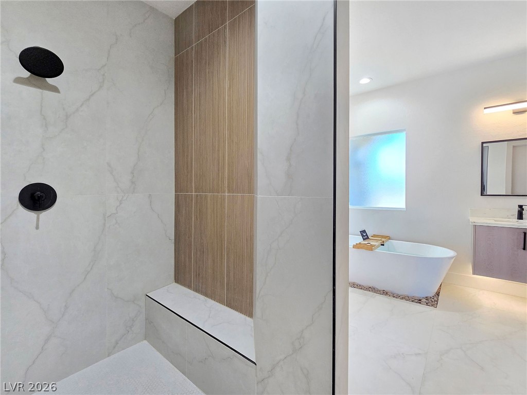 1120 West Gamebird Road Pahrump, NV 89048 - Photo 32 of 36 Full bath with a freestanding bath, vanity, a marble finish shower, marble finish flooring, and recessed lighting