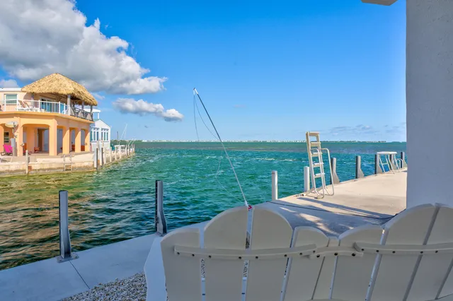 a balcony with furniture and a potted plant