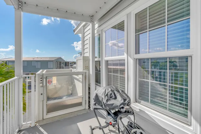 a kitchen with stainless steel appliances granite countertop a stove top oven a sink dishwasher a dining table and chairs with wooden floor