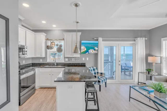 a kitchen with white cabinets and refrigerator