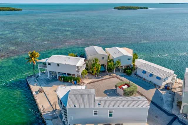 a view of a patio with a table and chairs under an umbrella