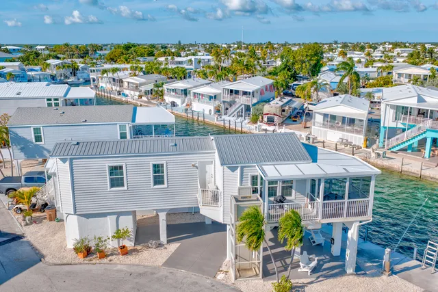 a view of a house with a yard and a garage
