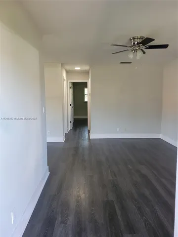 a view of a room with wooden floor and white walls