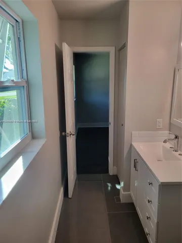 a view of bathroom with a sink and mirror
