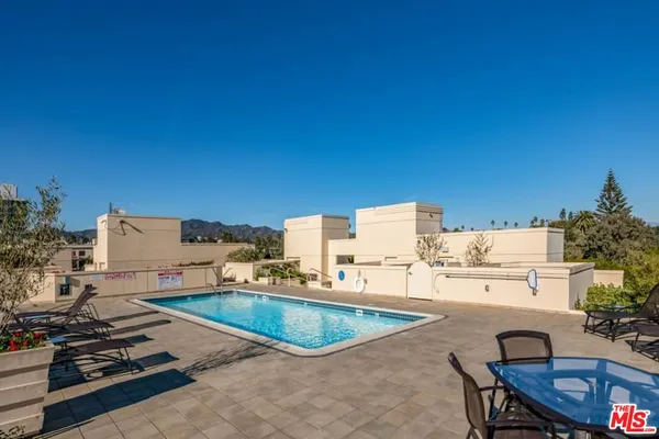 a view of a swimming pool and chairs