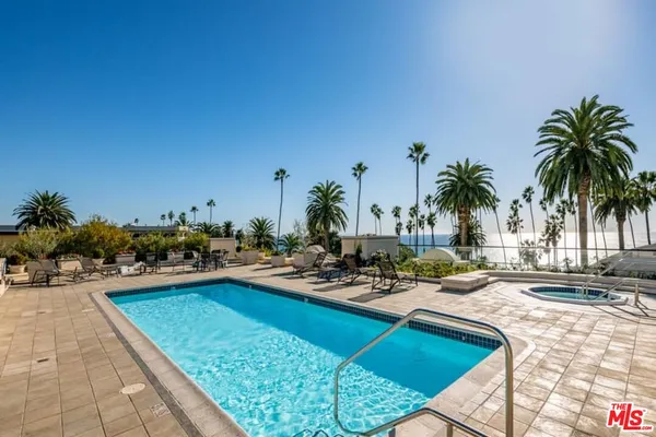 a view of a swimming pool and lounge chair