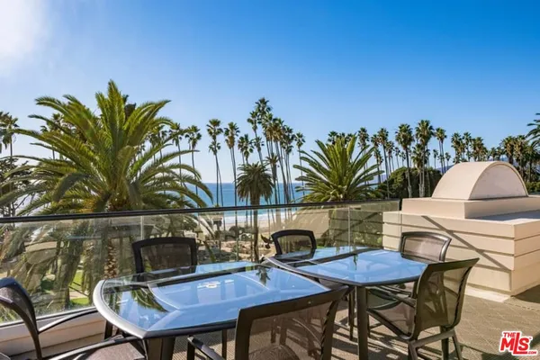 a view of a chairs and table in patio