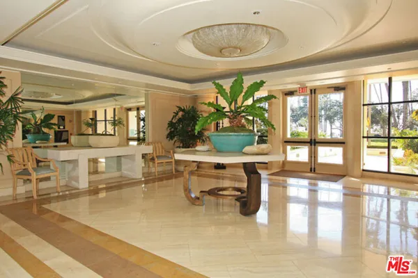 a living room filled with furniture and a large window