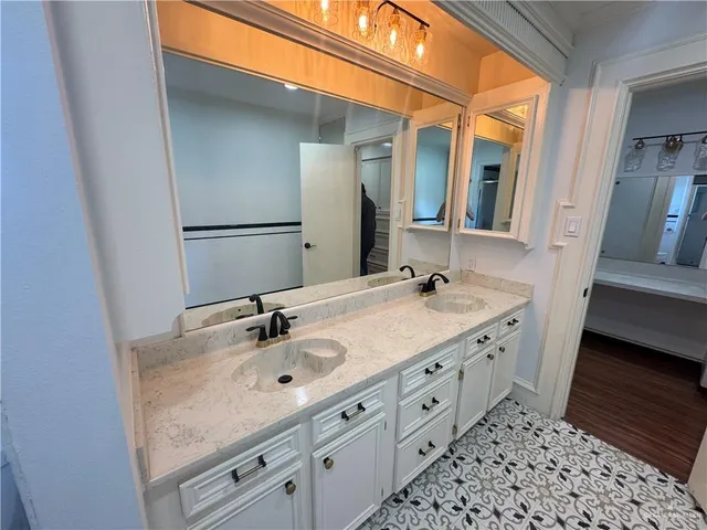 a bathroom with a double vanity sink and a mirror
