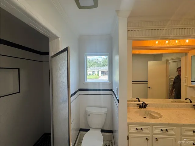 a bathroom with a granite countertop sink toilet and shower