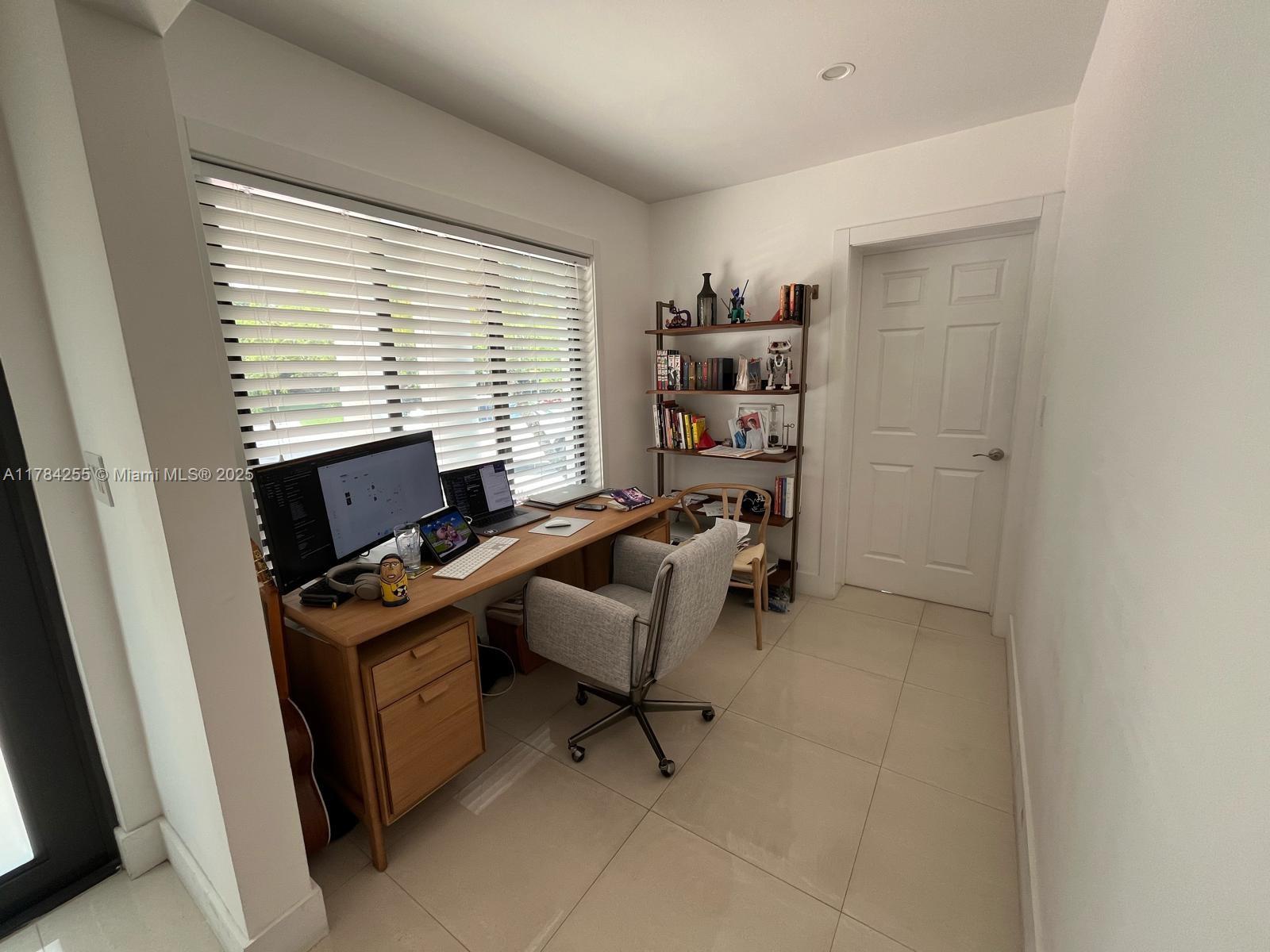 Tropical Isle Homes Key Biscayne, FL 33149 - Photo 11 of 38 a view of a workspace with furniture and a window