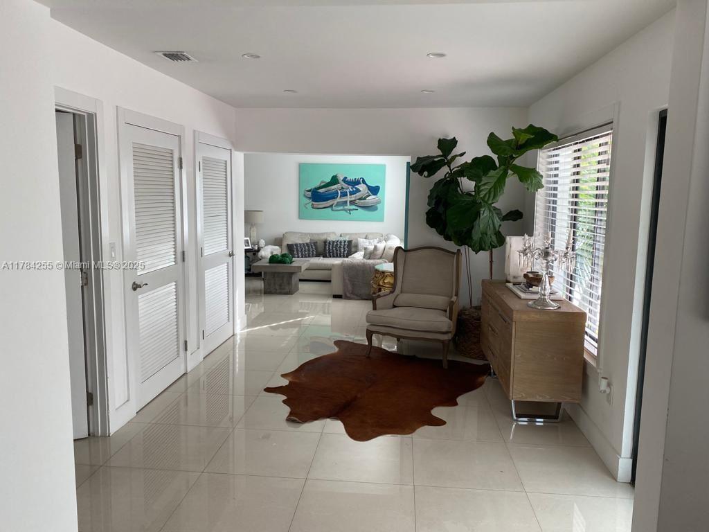 Tropical Isle Homes Key Biscayne, FL 33149 - Photo 14 of 38 a living room with furniture and a window