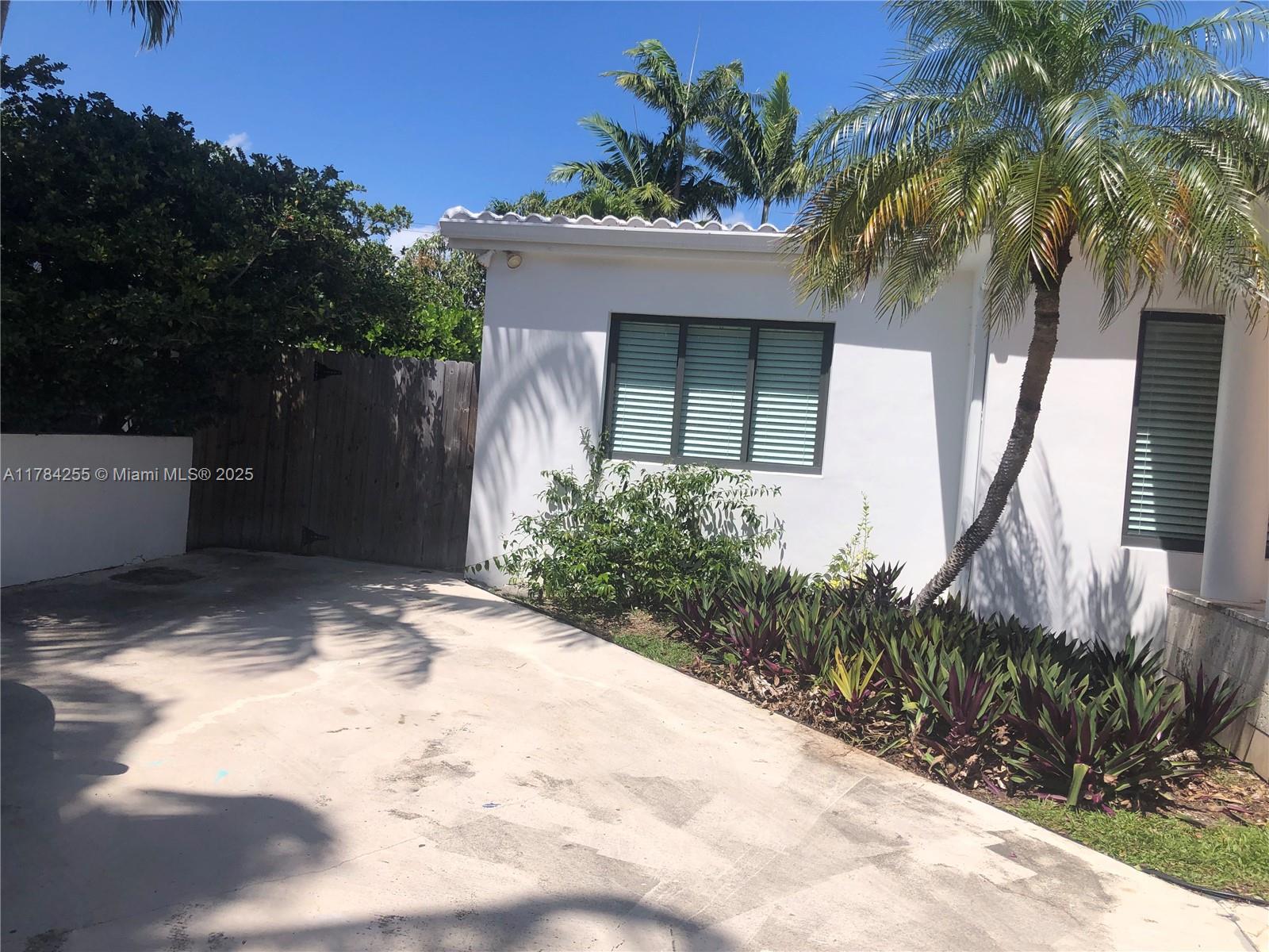 Tropical Isle Homes Key Biscayne, FL 33149 - Photo 15 of 38 a front view of a house with a yard