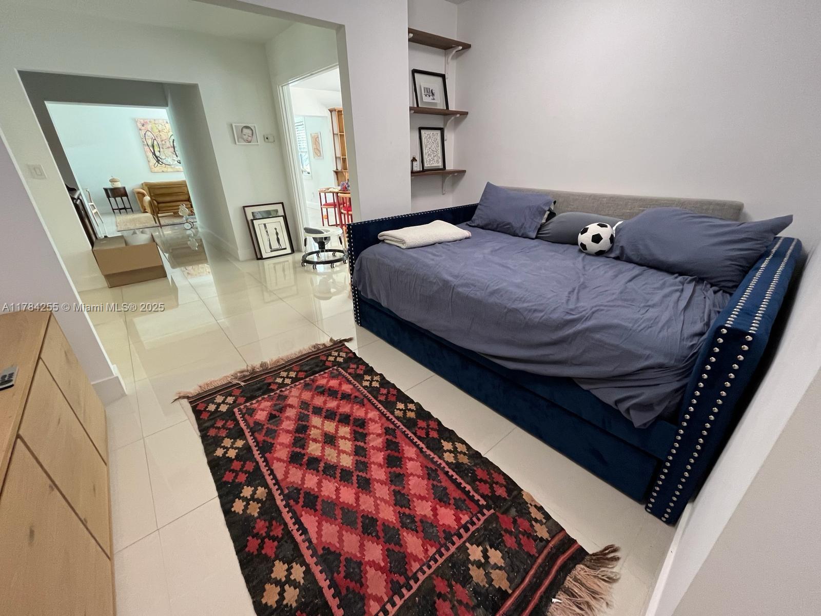 Tropical Isle Homes Key Biscayne, FL 33149 - Photo 20 of 38 a bedroom with bed and wooden floor