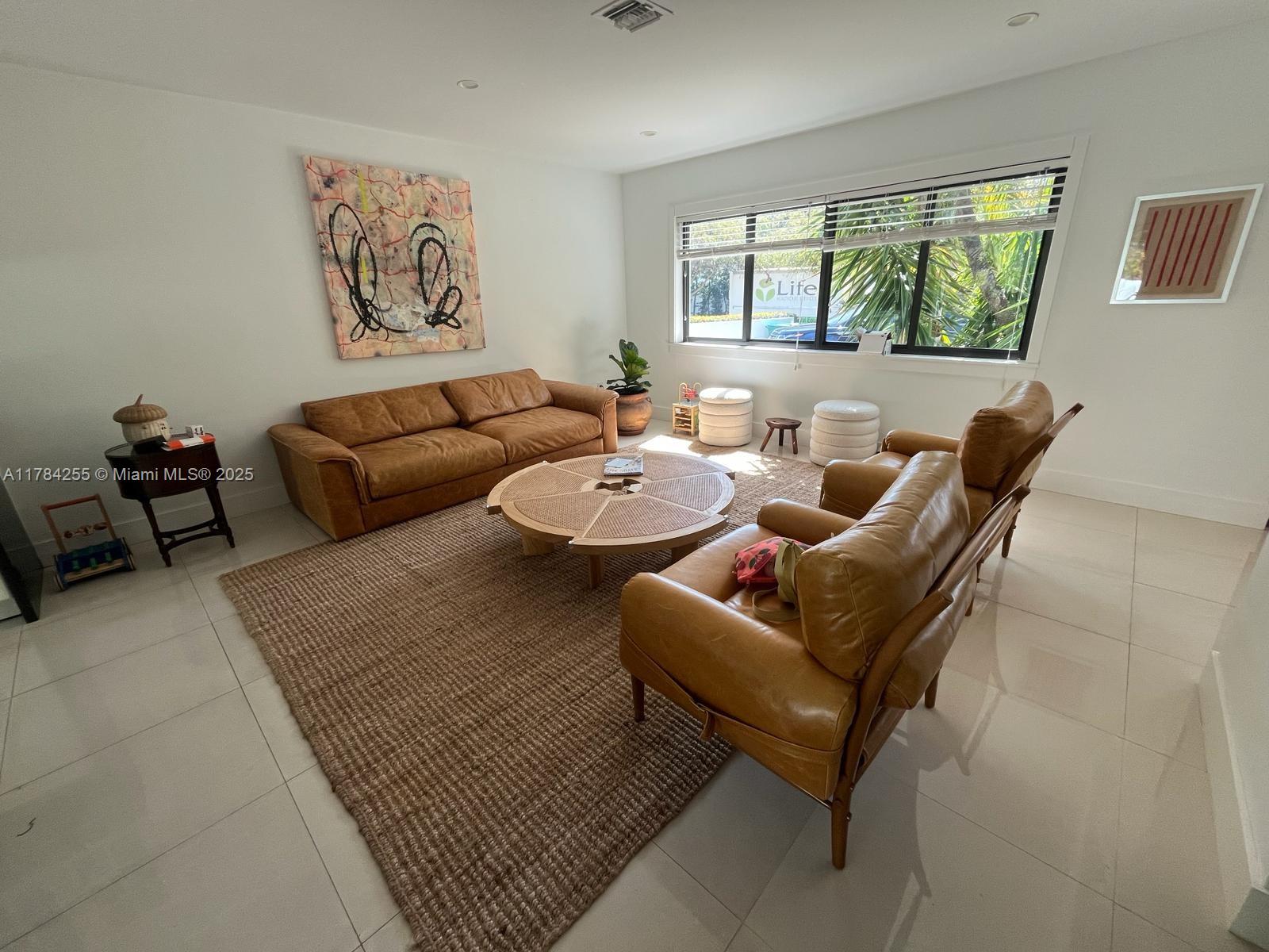 Tropical Isle Homes Key Biscayne, FL 33149 - Photo 2 of 38 a living room with furniture and a large window