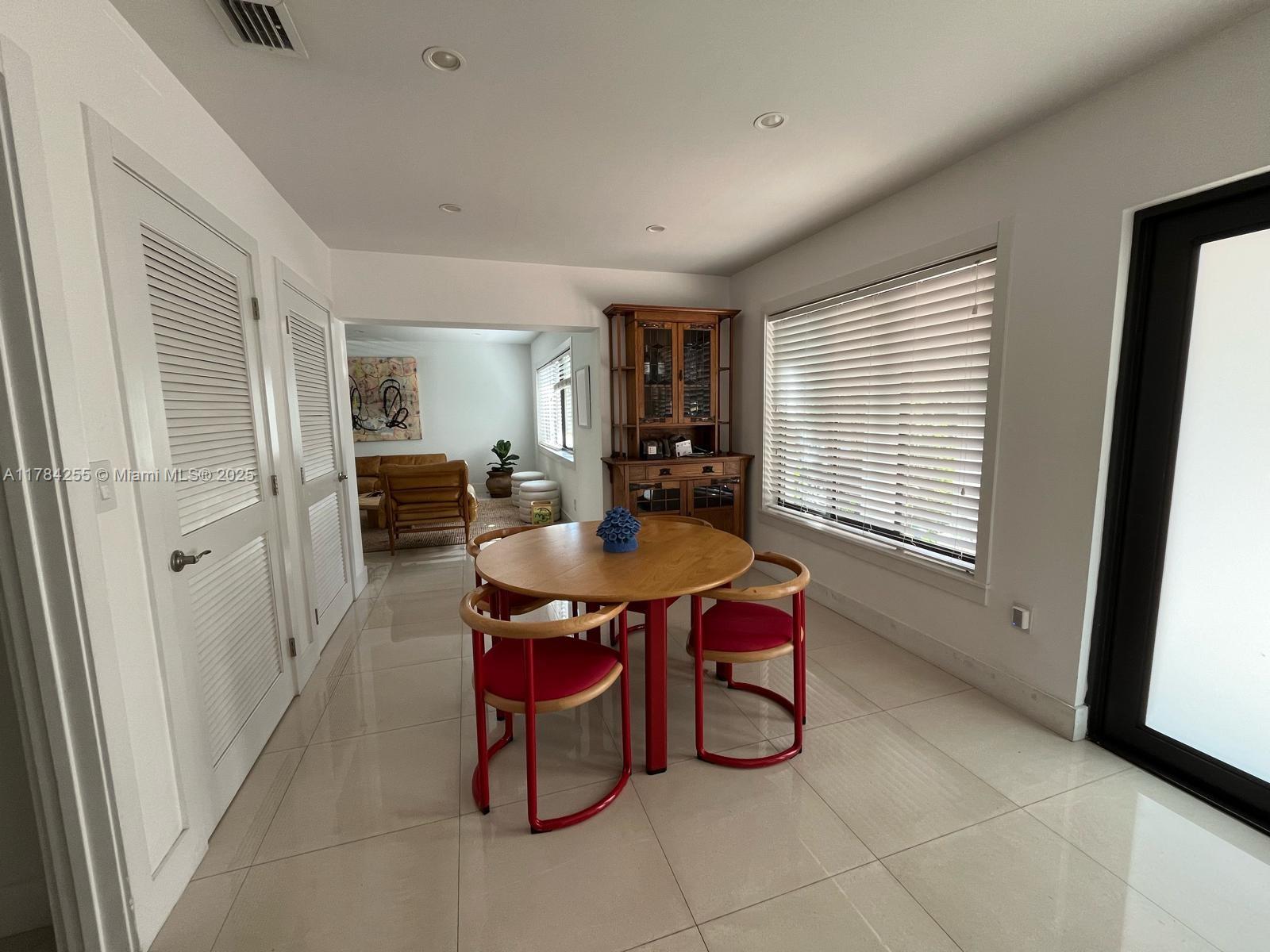 Tropical Isle Homes Key Biscayne, FL 33149 - Photo 21 of 38 a dining room with furniture and window