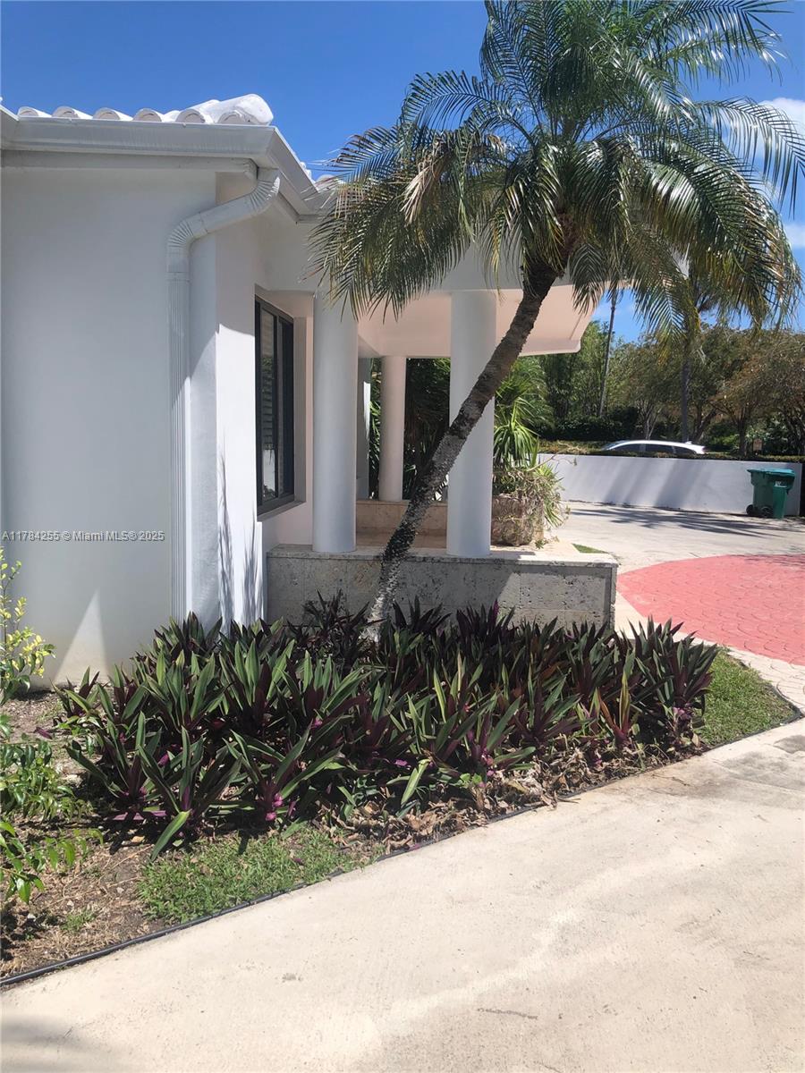 Tropical Isle Homes Key Biscayne, FL 33149 - Photo 23 of 38 a front view of a house with a yard