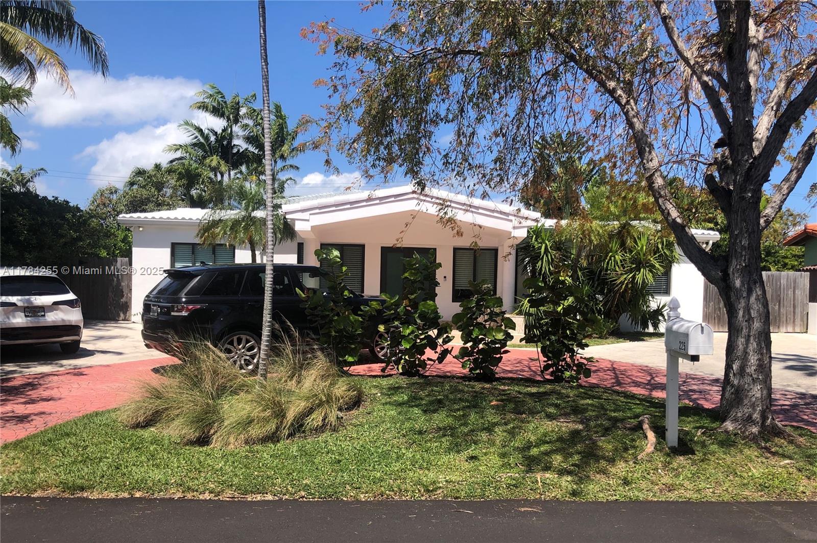 Tropical Isle Homes Key Biscayne, FL 33149 - Photo 24 of 38 a view of a house with a yard patio and a garden