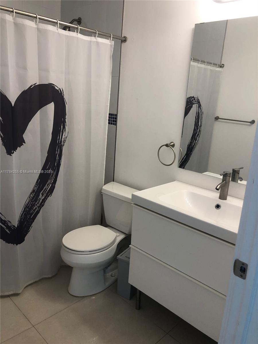 Tropical Isle Homes Key Biscayne, FL 33149 - Photo 25 of 38 a bathroom with a sink toilet and shower