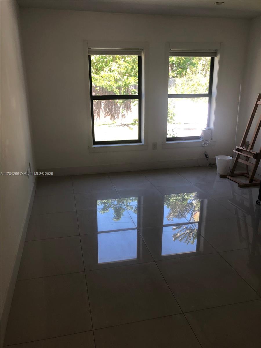Tropical Isle Homes Key Biscayne, FL 33149 - Photo 26 of 38 a view of window and wooden floor in a room