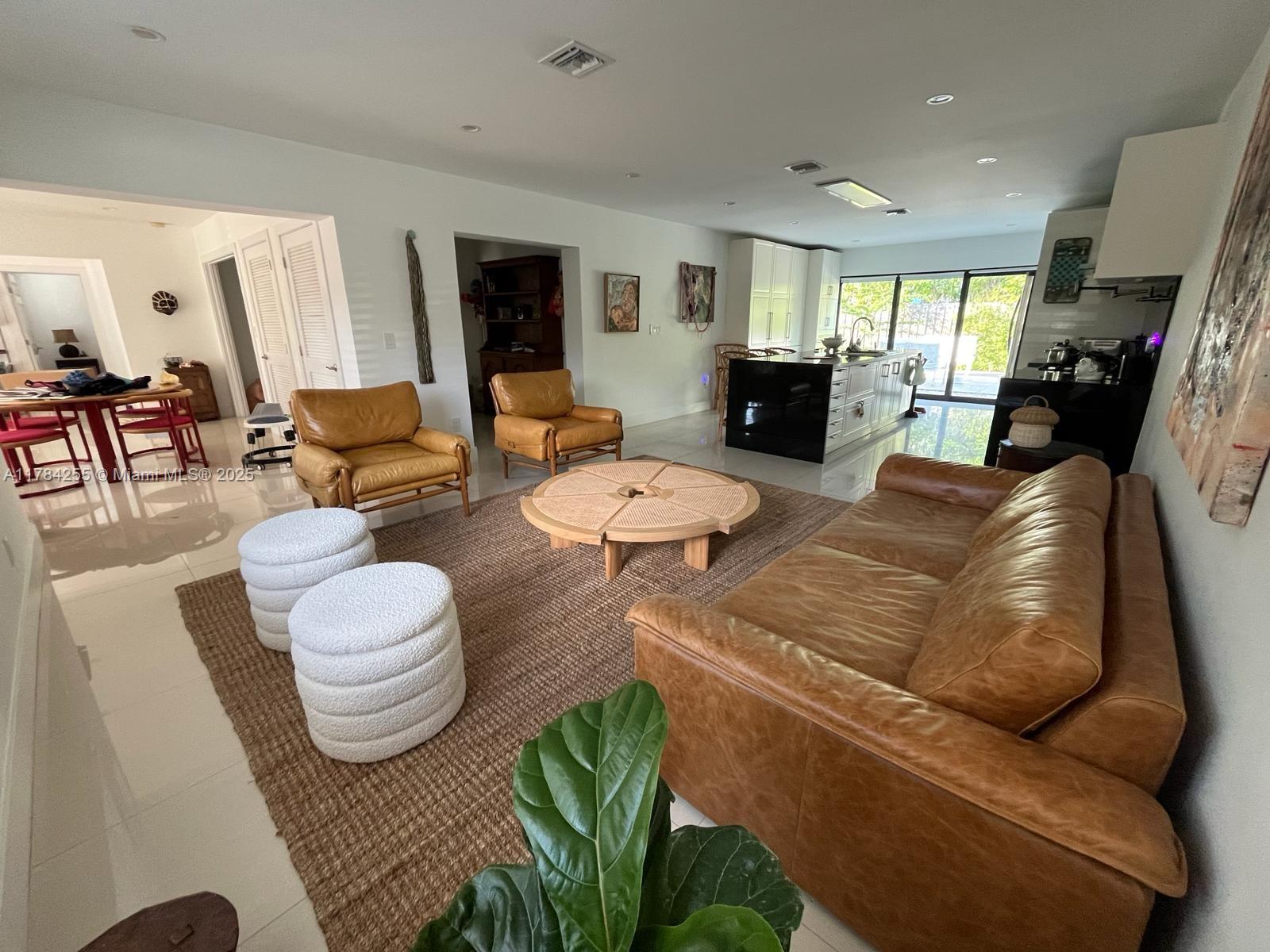 Tropical Isle Homes Key Biscayne, FL 33149 - Photo 3 of 38 a living room with furniture and a wooden floor