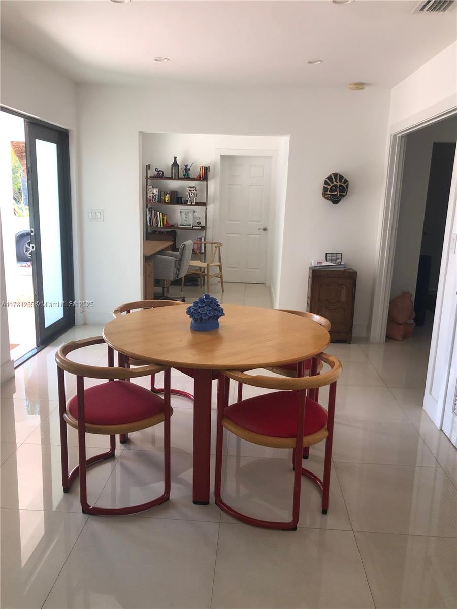 Tropical Isle Homes Key Biscayne, FL 33149 - Photo 36 of 38 a view of a dining room with furniture
