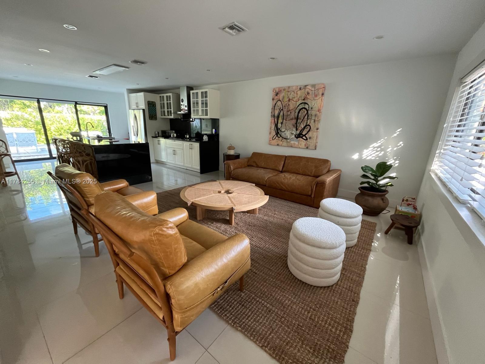 Tropical Isle Homes Key Biscayne, FL 33149 - Photo 4 of 38 a living room with furniture and a large window