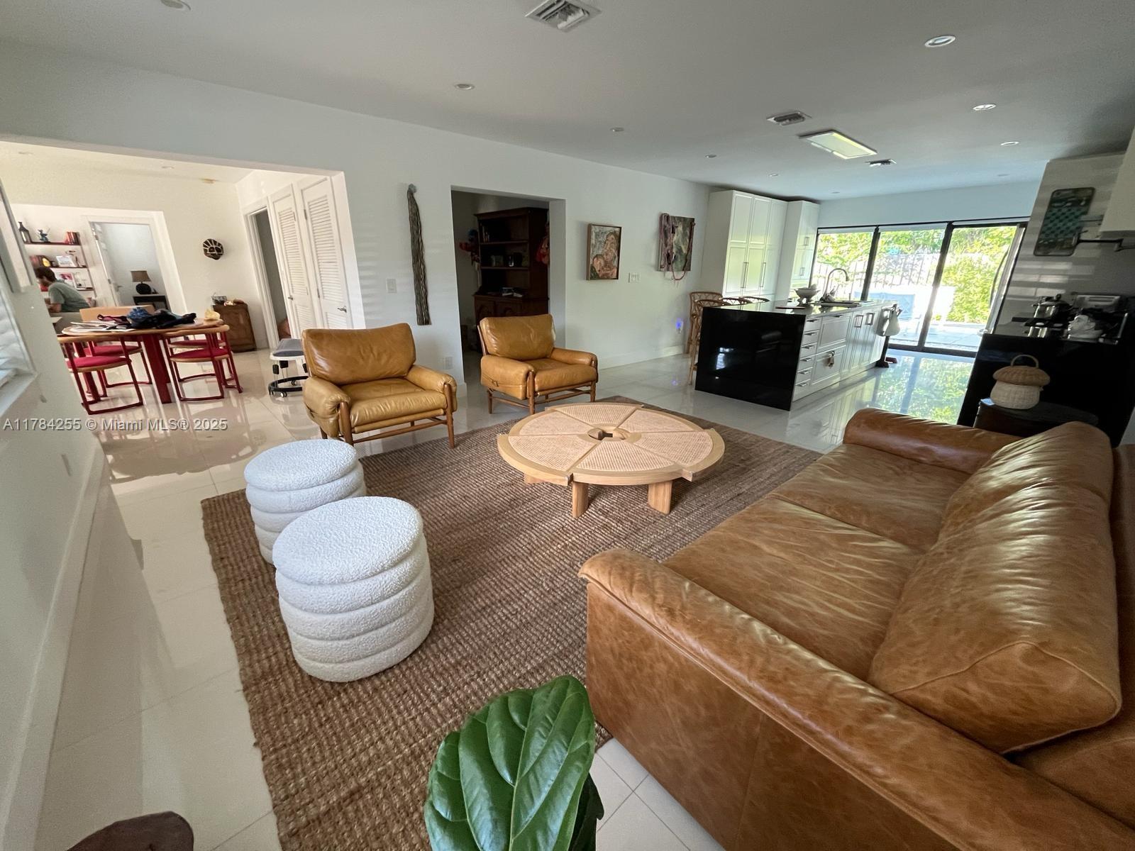 Tropical Isle Homes Key Biscayne, FL 33149 - Photo 6 of 38 a living room with furniture and a flat screen tv
