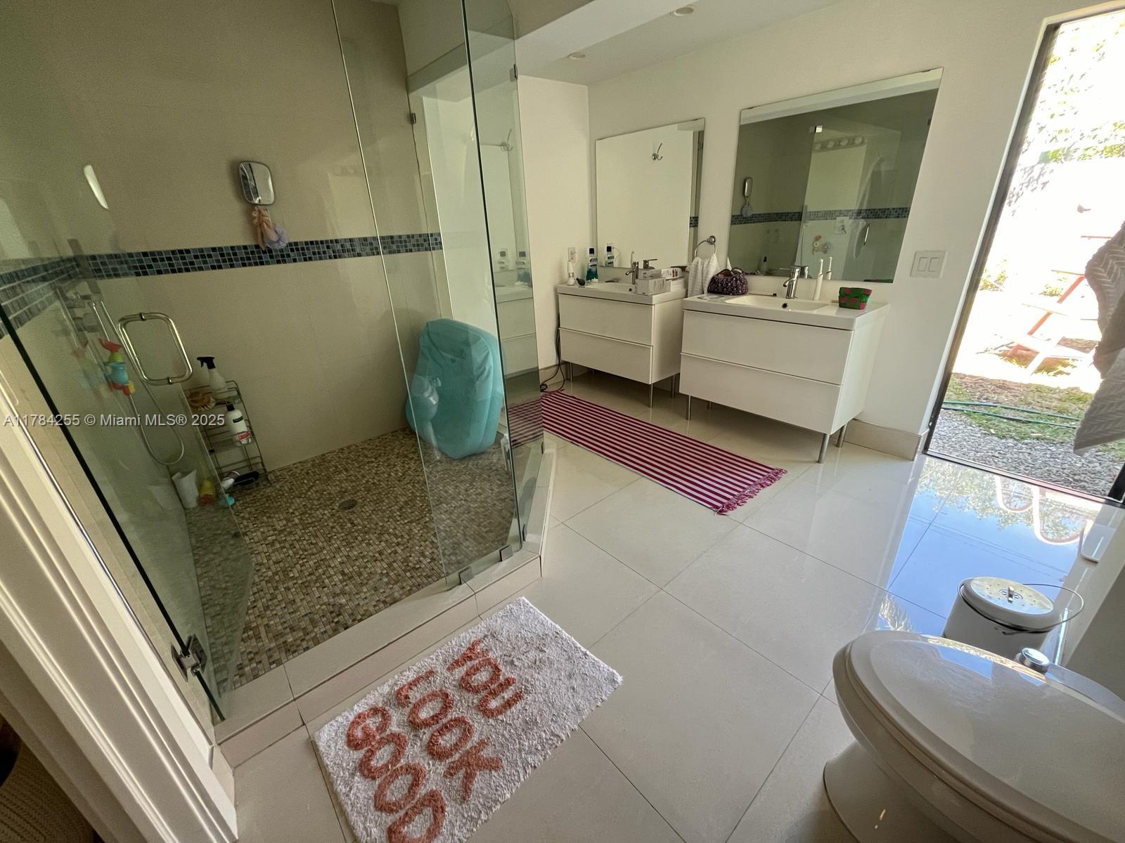 Tropical Isle Homes Key Biscayne, FL 33149 - Photo 7 of 38 a living room with furniture and a rug