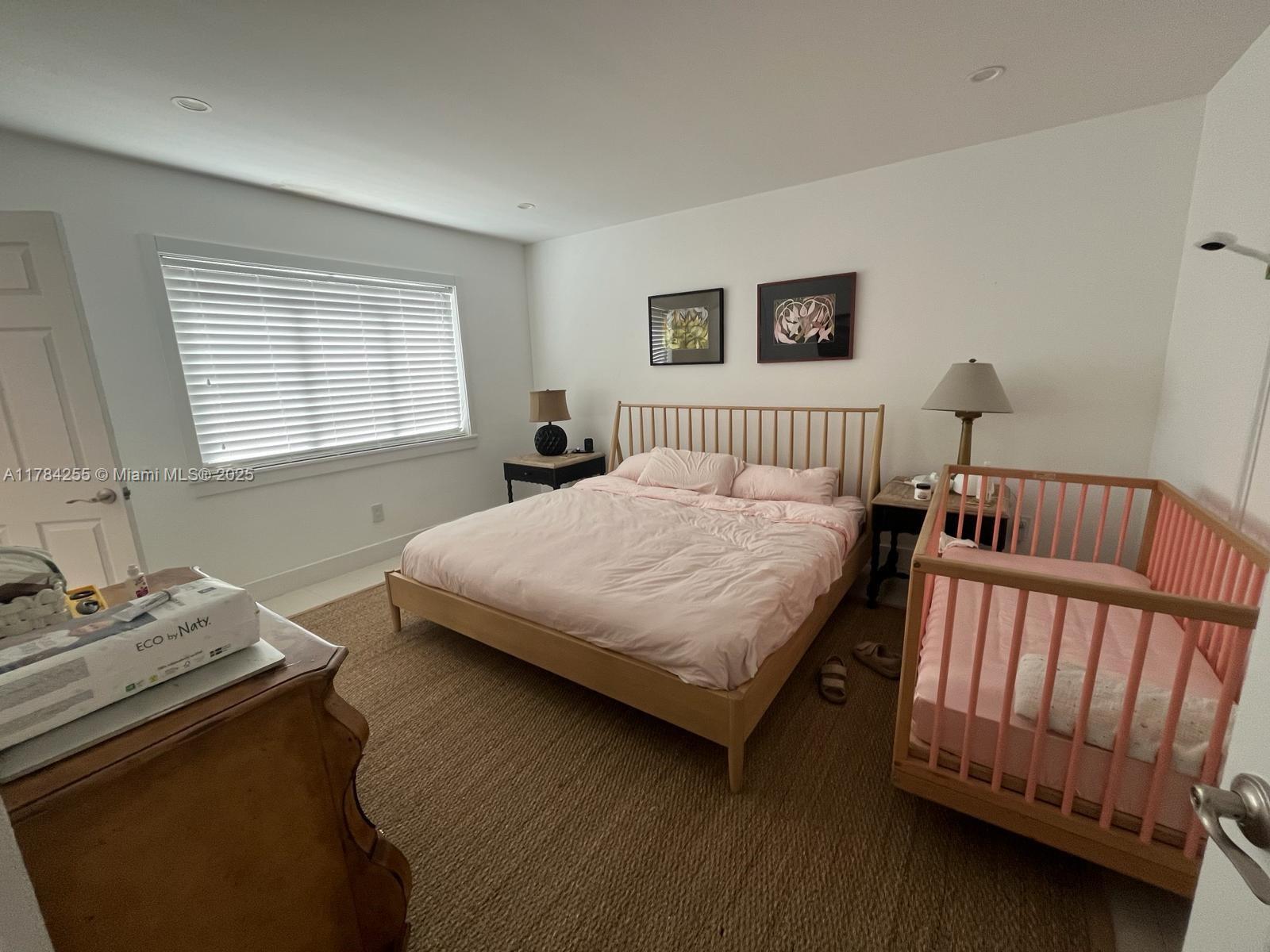 Tropical Isle Homes Key Biscayne, FL 33149 - Photo 8 of 38 a bedroom with a bed and a window