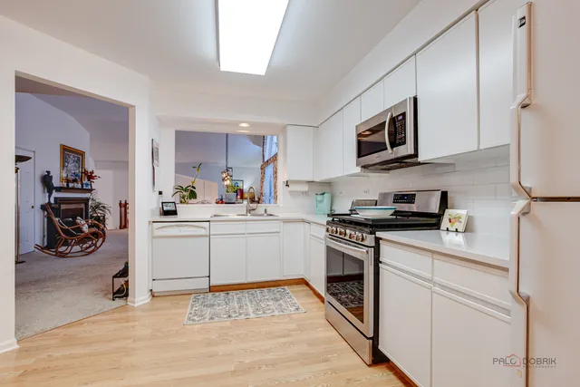 a kitchen with stainless steel appliances granite countertop a stove and a sink