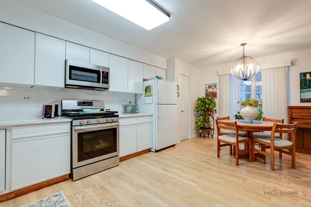 a kitchen with refrigerator and cabinets