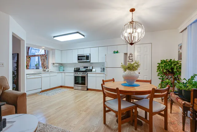 a kitchen with a dining table and chairs