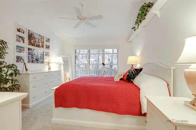 a bedroom with a bed and a potted plant