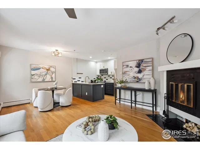a living room with furniture a pool table and a fireplace