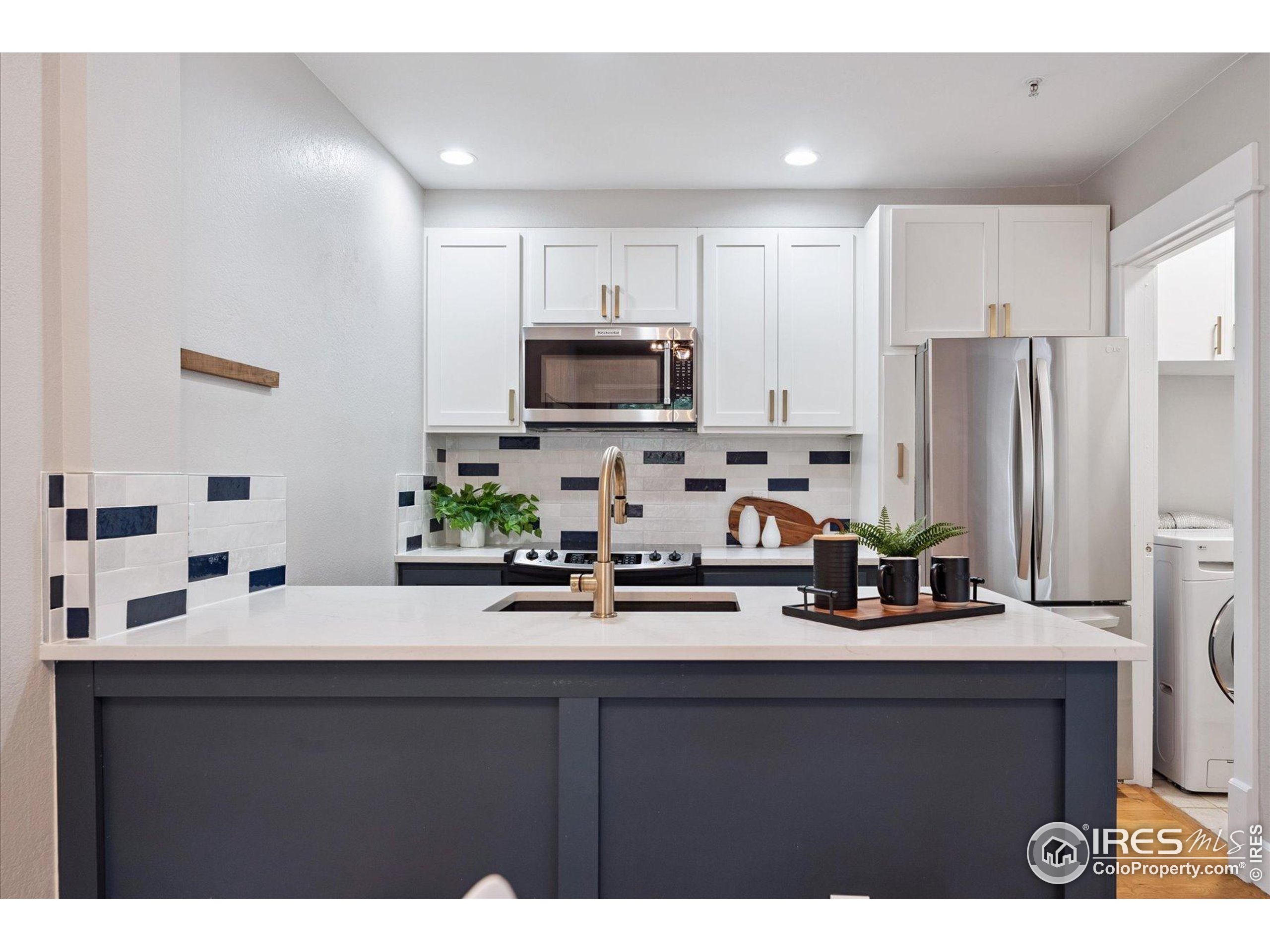 2201 Pearl Street, Unit 2 Boulder, CO 80302 - Photo 2 of 37 a kitchen with kitchen island a sink stainless steel appliances and cabinets