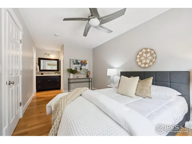 a bedroom with a large bed and a chandelier
