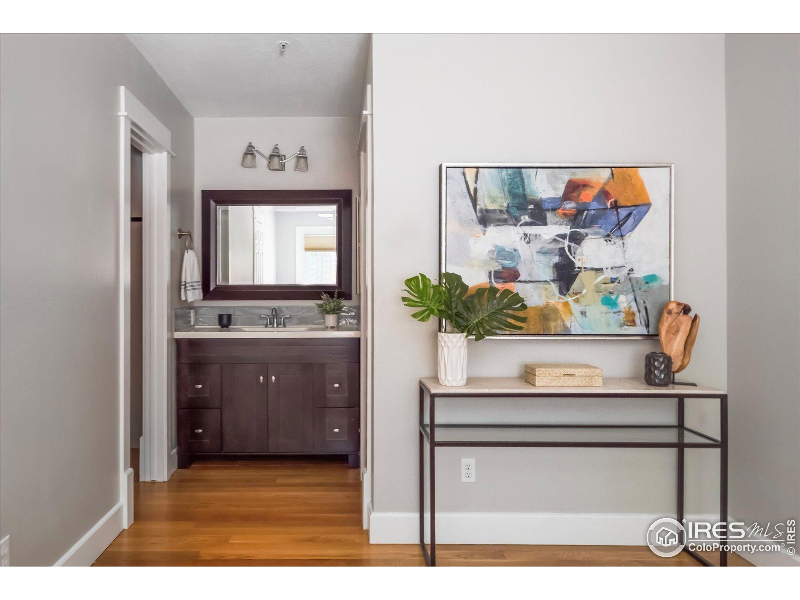 2201 Pearl Street, Unit 2 Boulder, CO 80302 - Photo 22 of 37 a living room with a wooden floor and a potted plant