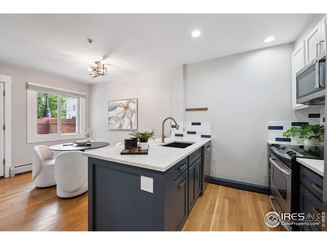 a kitchen with a sink appliances and cabinets