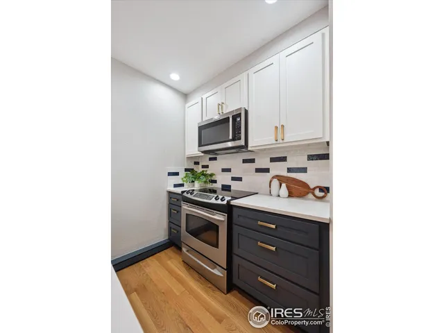 a kitchen with stainless steel appliances granite countertop a stove and a refrigerator