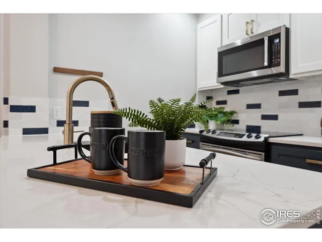 a kitchen with a microwave a stove and cabinets
