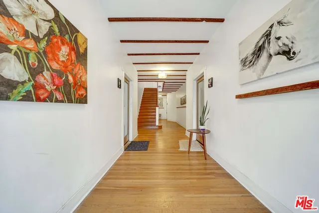 a view of a kitchen with wooden floor and a sink