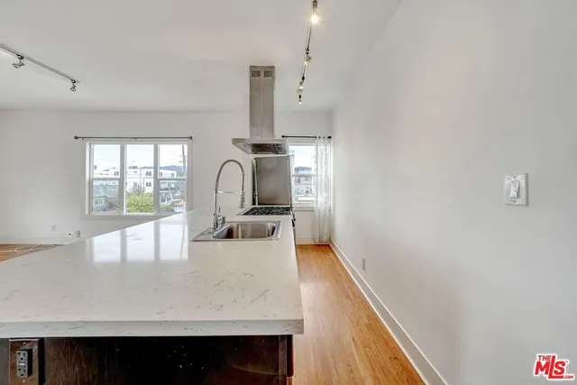 a view of kitchen and hall with wooden floor