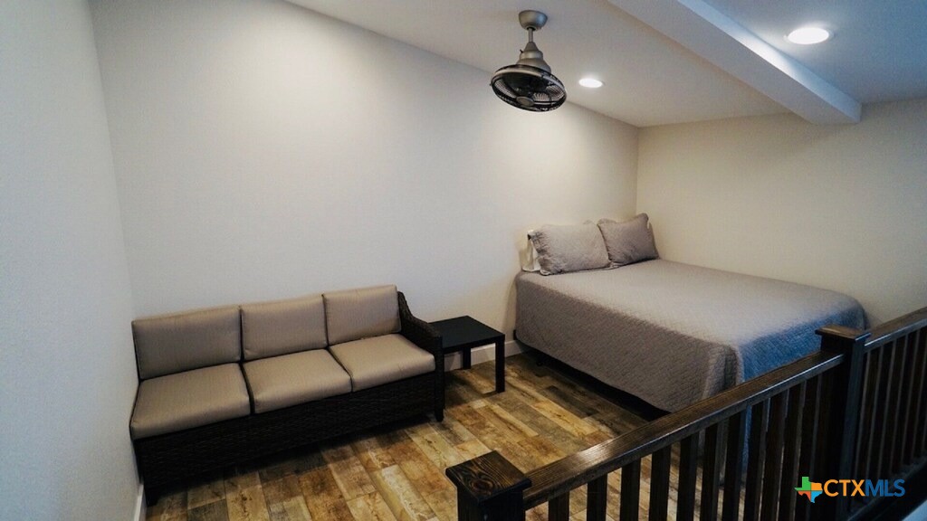 1206 Commerce Street Port O'Connor, TX 77982 - Photo 3 of 9 a bedroom with furniture and a ceiling fan