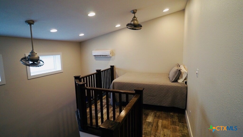 1206 Commerce Street Port O'Connor, TX 77982 - Photo 7 of 9 a bedroom with a bed and a chandelier